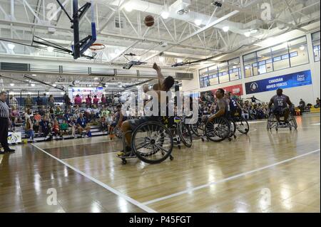 Army Spc, June 4, 2018. Vairon Caicedo Ocampo from Team SOCOM takes a shot against Navy in the wheelchair basketball game during the 2018 Warrior Games held at the Air Force Academy in Colorado Springs June 4, 2018. Several members of Team SOCOM advanced to the finals. Created in 2010, the DoD Warrior Games introduce wounded, ill and injured service members and veterans to Paralympic-style sports. Warrior Games showcases the resilient spirit of today's wounded, ill or injured service members from all branches of the military. These athletes have overcome significant physical and behavioral inj Stock Photo