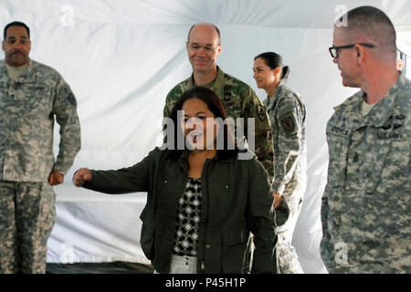 The Honorable Debra S. Wada, Assistant Secretary of the Army Manpower and Reserve Affairs enters a briefing during the Combat Support Training Exercise 91-16-02 hosted by the 91st Training Division at Fort Hunter Ligget, Calif.  The tent was called to attention to which Honorable Wada replied by yelling “Hooah” to the group of Soldiers attending the briefing on June 15, 2016.  Honorable Wada was followed by Brig. Gen. Chris Gentry, Commanding General 91st Training Division, who delivered the brief.  (Photo by 1st Lt. Kevin Braafladt, 91st Training Division Public Affairs.) Stock Photo