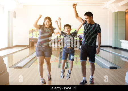 Family having fun at bowling club after skittles bowling ball ,blurry and soft focus Stock Photo