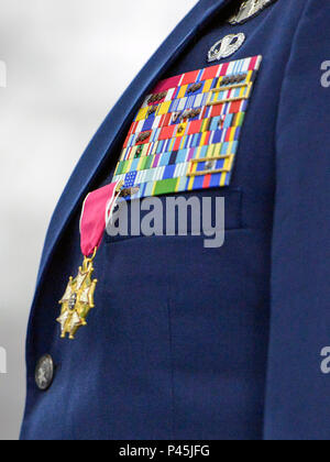 Lt. Gen. Samuel D. Cox, 18th Air Force commander, presents Col. John C. Millard, 89th Airlift Wing commander, with a Legion of Merit medal, during a change-of-command ceremony at Joint Base Andrews, Md., June 17, 2016, at which Millard relinquished command to Col. Casey D. Eaton. The 89th AW is a combat-ready wing of more than 1,100 Airmen and provides Special Airlift Mission airlift and support to the president, vice president, cabinet members, combatant commanders and other senior military and elected leaders, supporting White House, Air Force chief of staff and Air Mobility Command missions Stock Photo