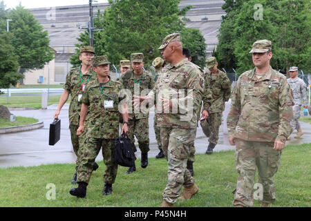 Maj. Gen. Mitsuhiko Horikiri, vice chief of staff (international), Japan Ground Self-Defense Force Central Readiness Force and Lt. Col. Frank E. Hopkins (left), deputy commander, 303rd Maneuver Enhancement Brigade, meet during Exercise Imua Dawn 2016, Sagamihara Depot, Japan, June 18, 2016. Imua Dawn 2016 provides opportunities for U.S. and the Japan Ground Self-Defense Force to come together and train for potential real world events, better preparing them in supporting regional populations in all Humanitarian Assistance and Disaster Relief (HADR) and Noncombatant Evacuation Operations (NEO).  Stock Photo