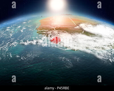 Sunrise above Sierra Leone highlighted in red on model of planet Earth ...