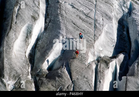 Climbers and their shadows on the glacier Trelatete and crevasse in the French Alps Stock Photo