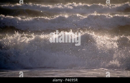 Sunlit waves on a beach Stock Photo