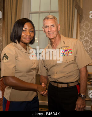 Lt. Gen. Rex C. McMillian (right), commander of Marine Forces Reserve and Marine Forces North, congratulates Cpl. Shereka K. Slater (left), an administrative specialist with Marine Forces Reserve Installation Personnel Administration Center, who received the Navy League of the United States Greater New Orleans Council’s Marine of the Year Award for Marine Forces Reserve at “A Taste’n Toast to Our Armed Services” event at the Bourbon Orleans Hotel, New Orleans, July 30, 2016.  The award was presented to Slater for her outstanding service to MARFORRES. The Navy League is comprised of 40,000 civi Stock Photo