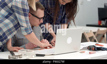 Young architects checking drawing measurements with divider Stock Photo