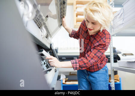 Young woman checking printer Stock Photo