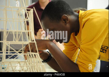 A middle school student constructed a balsa wood tower during the 2016 STEM Summer Academy at Naval Surface Warfare Center Dahlgren Division, Virginia. The program focused on developing teamwork, problem-solving, engineering, and science skills, with students collaborating with teachers and NSWCDD scientists and engineers to apply STEM principles in practical projects. Stock Photo