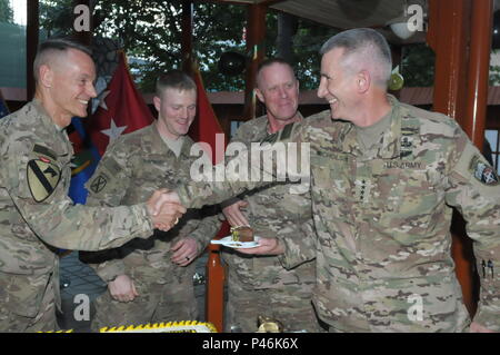 Gen. John W. Nicholson, Resolute Support commander shakes hands with Maj. Gen. Gordon “Skip” B. Davis, Jr., Deputy Chief of Staff - Security Assistance/Combined Security Transition Command – Afghanistan commanding general, at the Army Birthday cake-cutting ceremony here on Camp Resolute Support in Kabul Afghanistan.  Davis had just cut the Army Birthday cake with the youngest and oldest enlisted soldiers here, Sgt. Cody Summers and Master Sgt. James Bryan.  The Army celebrates its birthday on June 14 in recognition of the Second Continental Congress establishing the Continental Army on June 14 Stock Photo