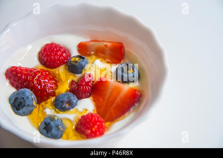 Cream with berries and honey. Close view. Stock Photo