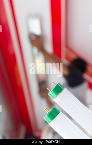Setup fluorescent light green power on ceiling, selection focus, copy space background. Stock Photo