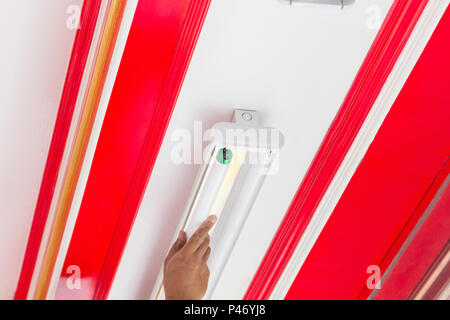 Setup fluorescent light green power on ceiling, selection focus, copy space background. Stock Photo