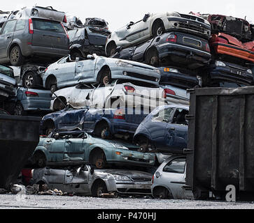 Scrapyard with car bodies piled up Stock Photo