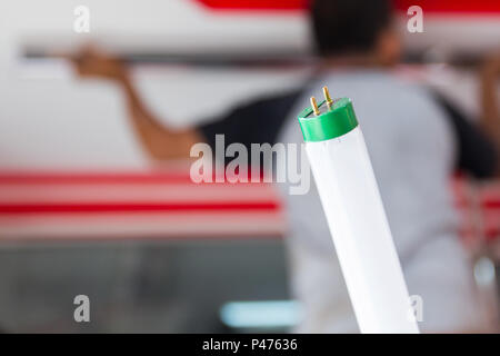 Setup fluorescent light green power on ceiling, selection focus, copy space background. Stock Photo