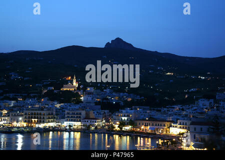 Town Tinos at night with mountain Exombourgo, island Tinos, Cyclades, Greece Stock Photo