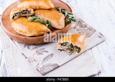 Homemade pies with spinach and cheese. baking on white background. Tasty breakfast. Healti Food . Stock Photo