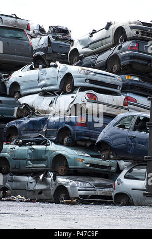 Breakers yard with car bodies piled up Stock Photo