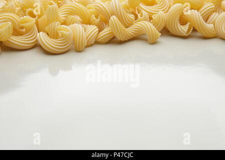 Group of macaroni pasta on gray background Stock Photo
