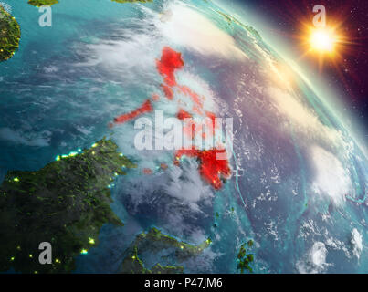 Sunrise above Philippines highlighted in red on model of planet Earth ...