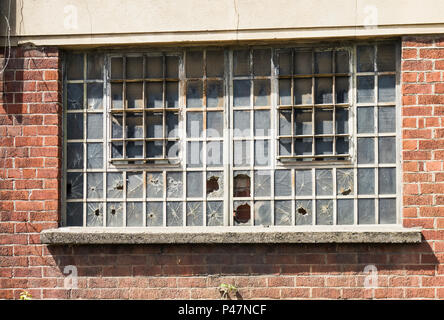 Broken windows on old derelict building. Stock Photo