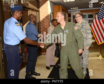 NEW CASTLE AIR NATIONAL GUARD BASE, Del. Col. Don Bevis, commander, 166th Airlift Wing, and Col. David Walker, vice commander, 166th Airlift Wing, greet members of the Republic of Trinidad and Tobago Defense Force (TTDF) as they arrive to the Delaware Air National Guard headquarters building. The four members present represent the coast guard and air guard of the Trinidad and Tobago Defence Force. The Delaware National Guard has a partnership with TTDF in the State Partnership Program, which has flourished over the past eleven years. TTDF members were given a tour of various DNG locations from Stock Photo
