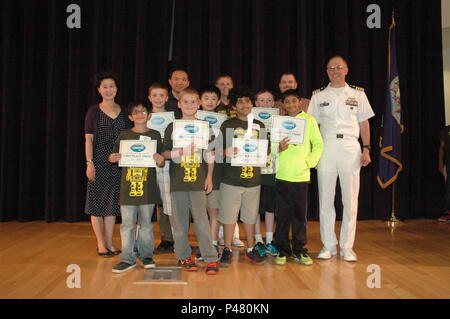 The first-place winners of the 2016 Carderock LEGO Robotics Competition, Forest Edge Robotics from Forest Edge Elementary in Reston, Virginia, pose with the Commanding Officer of Naval Surface Warfare Center, Carderock Division in West Bethesda, Maryland, on June 10, 2016. The competition promotes STEM education, problem-solving, and teamwork, encouraging students to apply engineering, programming, and design skills in a practical, collaborative environment. Stock Photo