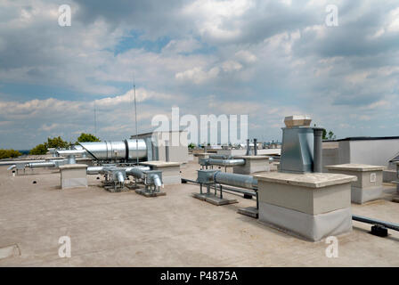 Elements of ventilation and air conditioning placed on the roof of a block of flats Stock Photo