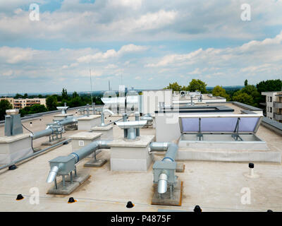 Elements of ventilation and air conditioning placed on the roof of a block of flats Stock Photo