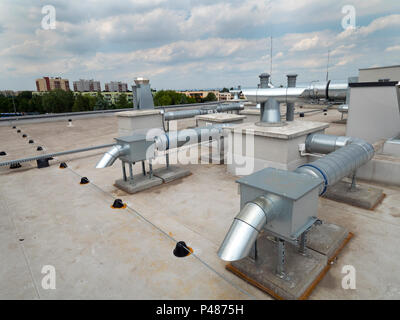 Elements of ventilation and air conditioning placed on the roof of a block of flats Stock Photo