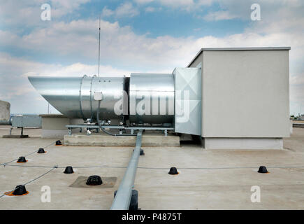 Elements of ventilation and air conditioning placed on the roof of a block of flats Stock Photo