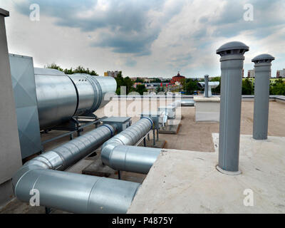 Elements of ventilation and air conditioning placed on the roof of a block of flats Stock Photo