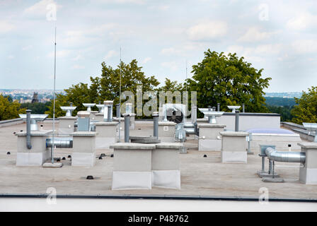 Elements of ventilation and air conditioning placed on the roof of a block of flats Stock Photo