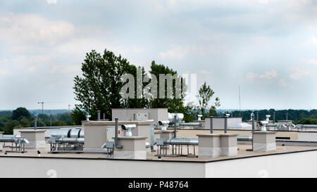 Elements of ventilation and air conditioning placed on the roof of a block of flats Stock Photo