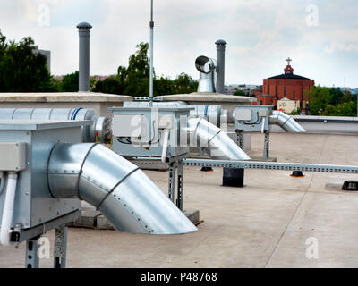 Elements of ventilation and air conditioning placed on the roof of a block of flats Stock Photo