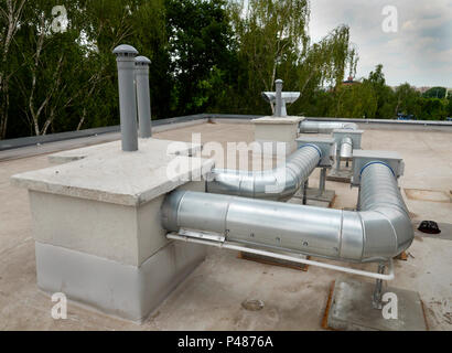 Elements of ventilation and air conditioning placed on the roof of a block of flats Stock Photo