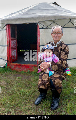 Grandfather with infant grandson outside their summertime yurt, Zhenglanqi Wuyi, Inner Mongolia, China, Inner Mongolia, China Stock Photo