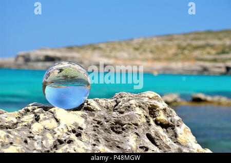 glass sphere on stone rocks Stock Photo