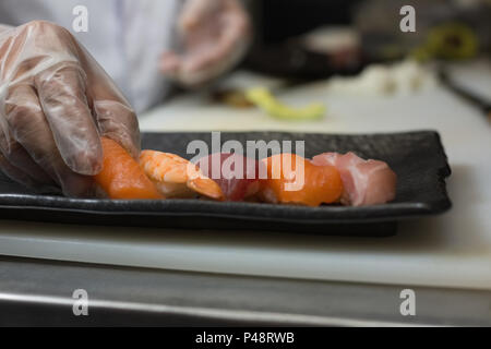 Chef holding sea food in kitchen Stock Photo