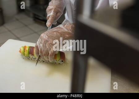 Senior chef preparing sushi in kitchen