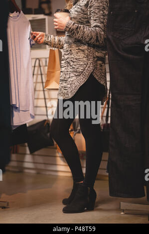 Low section of woman checking price tag Stock Photo