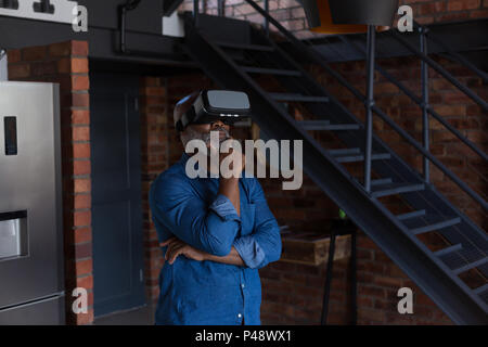 Senior man using virtual reality headset Stock Photo