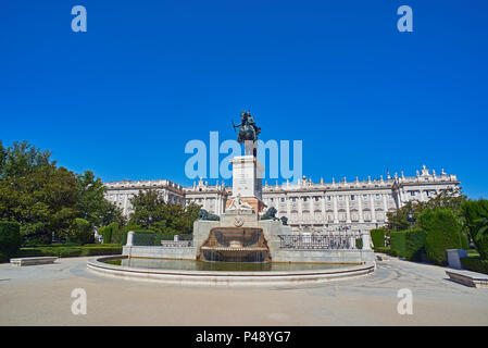East facade of Royal Palace of Madrid (Palacio Real) with Monument to Felipe IV in foreground. Plaza de Oriente Square. Madrid, Spain. Stock Photo