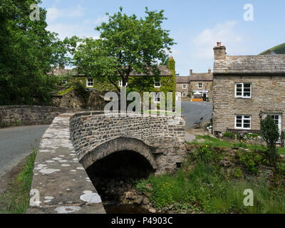 Looking into centre small pretty unspoilt village of Thwaite in Swaledale Yorkshire Dales National Park England UK Stock Photo