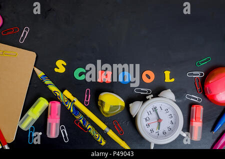 Flat lay with lettering back to school and set of school equipment on blackboard Stock Photo