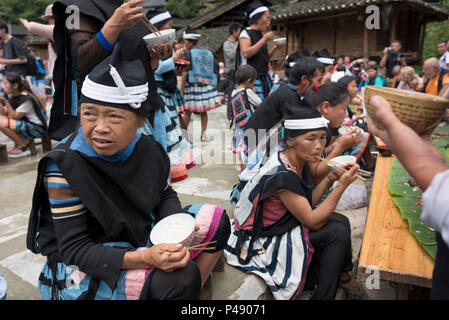 Women enjoy communal meal in village square, Yao ethnic minority village Yao Shan, Libo, Guizhou Province, China Stock Photo