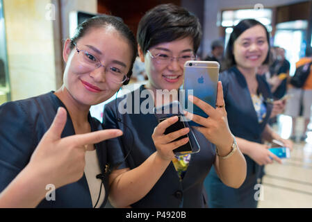 Luxury hotel staff greet foreign visitors in lobby, Beijing, China Stock Photo