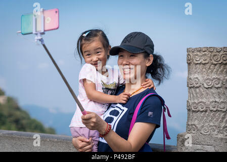 Tourists pose for photographs atop Mount Tai, Taian, Shangdong Province, China Stock Photo