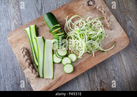 Top view of Courgette prepared on a wooden chopping board. Sliced, julienne and spaghetti Stock Photo