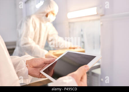Sports nutrition factory employee using tablet Stock Photo