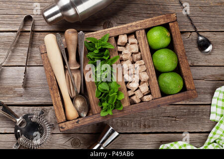 Mojito cocktail ingredients and bar accessories box on wooden table. Top view Stock Photo